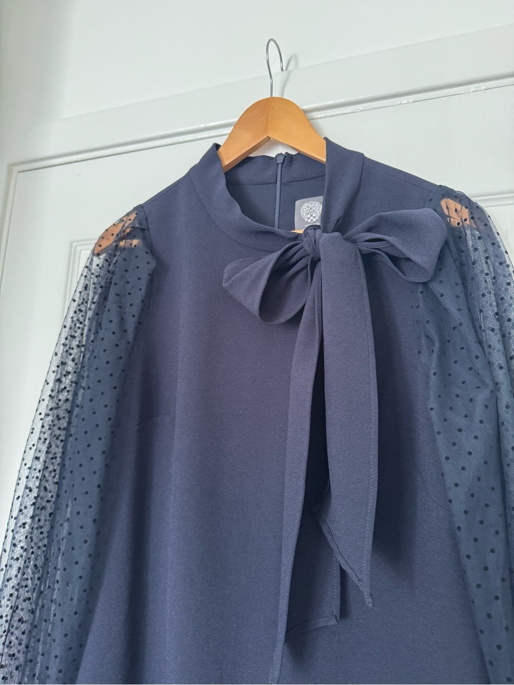 Vince camuto dress navy blue,polka dot with sheer sleeves and a bow detail.